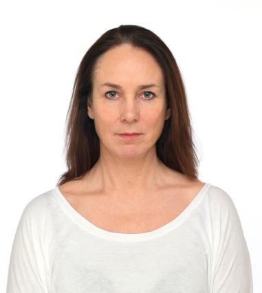 A woman with long brown hair, wearing a white shirt, is looking directly at the camera against a plain white background.